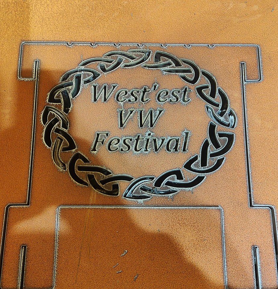 A flat laser-cut steel side panel showing the slot-together joints along its edges and a cut-out Celtic design